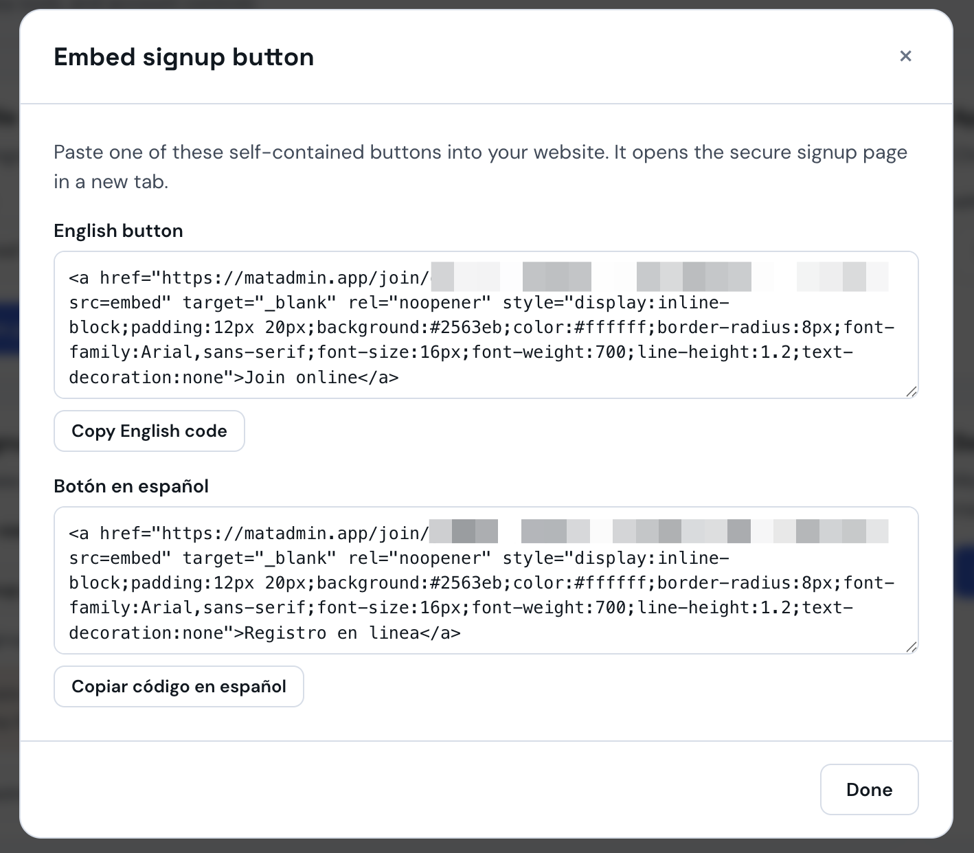 Embed signup button modal showing the English and Spanish code snippets with their copy buttons, signup token redacted